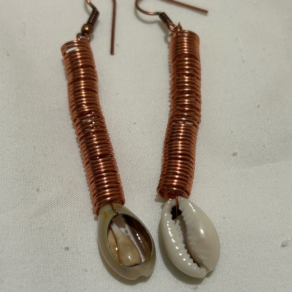 Handcrafted copper earrings with cowrie shells